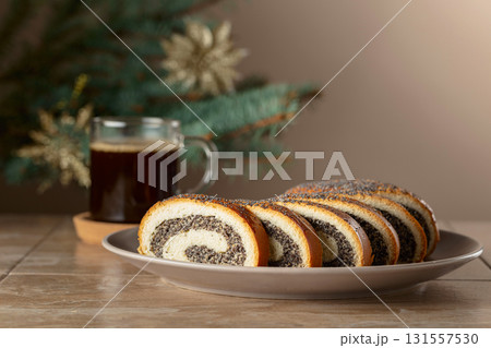 Poppy seed roll pieces and black coffee. 131557530