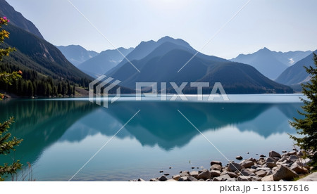 A serene lakeside setting in a mountainous region, with a tranquil lake mirroring the surrounding landscape 131557616