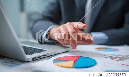 financial consultant pointing at pie chart on laptop financial consultant pointing at pie chart on laptop 131559276