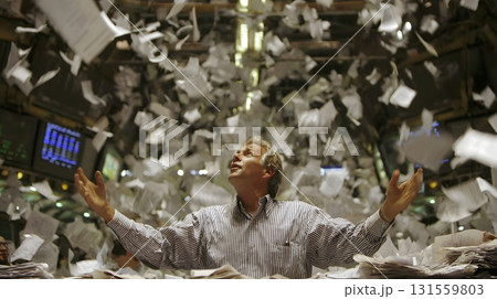 Trader throwing papers in air after loss 131559803