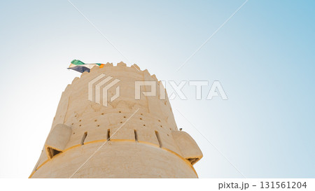Stone arabic watchtower with waving United Arab Emirates National Flag in Al Jazirah Al Hamra haunted town in Ras Al Khaimah. High quality photo Stone arabic watchtower with waving United Arab Emirates National Flag in Al Jazirah Al Hamra haunted town in Ras Al Khaimah. High quality photo 131561204