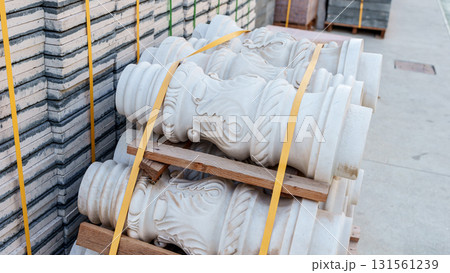 Pallets with stacked gray paving slabs selective focus Stack of paving slabs in warehouse road repair or finished tile sale space for text. High quality photo Pallets with stacked gray paving slabs selective focus Stack of paving slabs in warehouse road repair or finished tile sale space for text. High quality photo 131561239