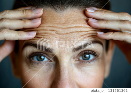 Close-up of a mature woman's face highlighting expressive forehead wrinkles. Concept Portrait Photography, Facial Features, Mature Beauty, Expressive Forehead Wrinkles, Close-Up Shot 131561361