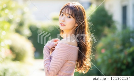 木漏れ日の中で優しくこちらに振り返るオフショルダーの女性 131562184