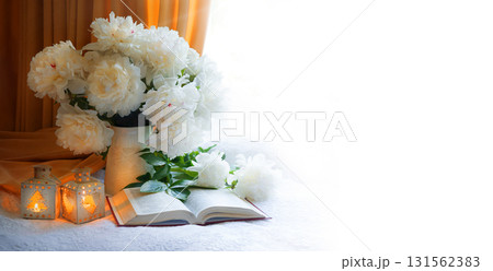 Flowers and book on the table 131562383