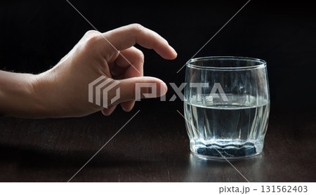 An optimist and a pessimist's opinion about a glass of water 131562403