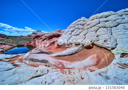 White Pocket Arizona Mosaic Rock Formation and Swirling Sandstone under Blue Sky White Pocket Arizona Mosaic Rock Formation and Swirling Sandstone under Blue Sky 131563040