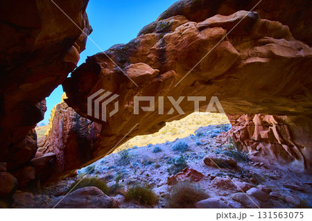 Natural Arch Formation And Desert Landscape Under Blue Sky Natural Arch Formation And Desert Landscape Under Blue Sky 131563075