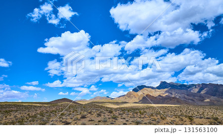 Desert Landscape With Rugged Mountains And Expansive Blue Sky Desert Landscape With Rugged Mountains And Expansive Blue Sky 131563100