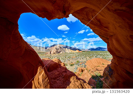 Red Sandstone Arch Formation Framing Desert Landscape in Nevada 131563420