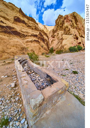 Stone Cistern and Layered Cliffs in Desert Landscape Stone Cistern and Layered Cliffs in Desert Landscape 131563447