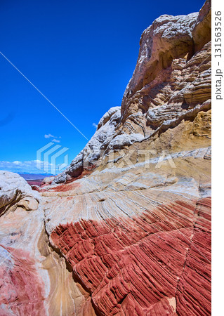 Vibrant Striated Sandstone and Rugged Cliffs White Pocket Arizona Low Angle Vibrant Striated Sandstone and Rugged Cliffs White Pocket Arizona Low Angle 131563526