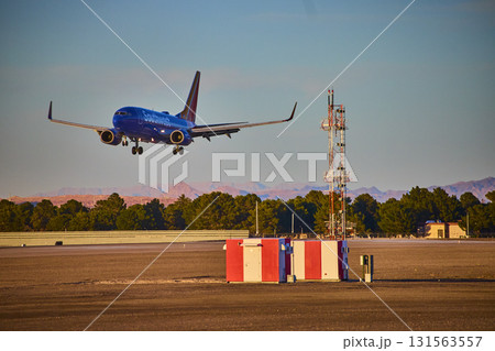 Airplane taxiing at Las Vegas airport in Nevada with city skyline in background 131563557
