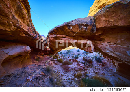 Sandstone Arch Formation Framed by Desert Landscape and Blue Sky Sandstone Arch Formation Framed by Desert Landscape and Blue Sky 131563672