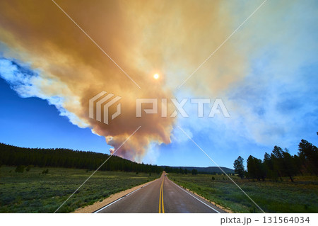 Wildfire Smoke Plume Over Scenic Road and Forest Under Sunlit Sky Utah 131564034