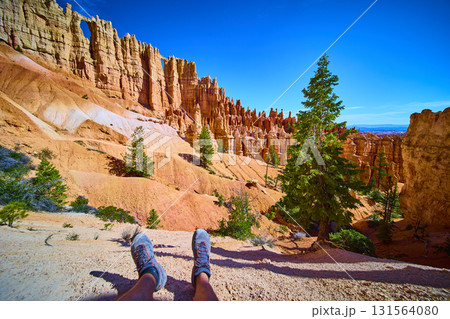 Hiker Feet Resting with Wall of Windows and Hoodoos in Bryce Canyon National Park Hiker Feet Resting with Wall of Windows and Hoodoos in Bryce Canyon National Park 131564080