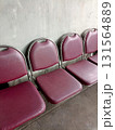 A Bench with Four Dark Red Cushions on Concrete Texture 131564889