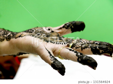 Picture of human hand being decorated with henna tattoo Picture of human hand being decorated with henna tattoo 131564924
