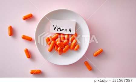 Orange capsule vitamin A supplement for healthy lifestyle  on white plate 131567087