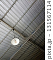 Industrial Metal Ceiling with Hanging White Light Fixture 131567114