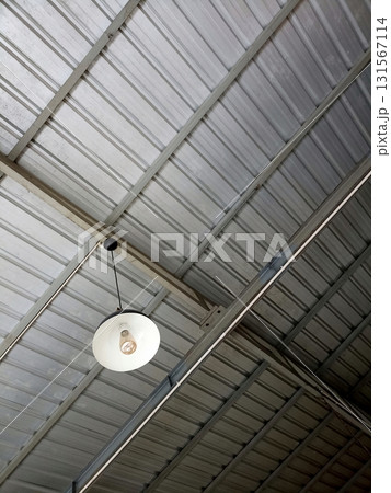 Industrial Metal Ceiling with Hanging White Light Fixture Industrial Metal Ceiling with Hanging White Light Fixture 131567114