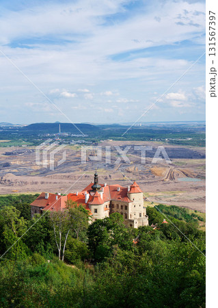 Jezeri Castle with Czechoslovak army coal mine in background, Horni Jiretin, Most district, Ustecky region, Czech Republic, sunny summer day 131567397