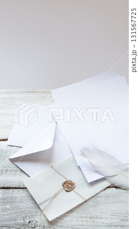 Envelope and paper on white wooden table Envelope and paper on white wooden table 131567725