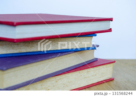 A clean vertical stack of multicolored books representing organization and focus. 131568244