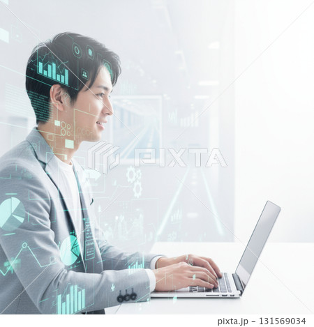 ビジネスシーン：パソコンを操作する若いビジネスマン　ビジネスアイコン　白色基調のモダンなオフィス 131569034