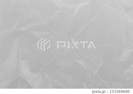 Close-up of transparent plastic texture with wrinkles clear background and crumpled surface detail 131569080