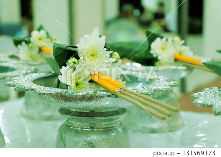 Flowers, incense, and candles on a tray. Flowers, incense, and candles on a tray. 131569173