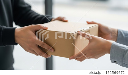 Hands exchanging a parcel box in a bright office environment 131569672