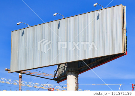 Large blank billboard with blue sky behind it. 131571159