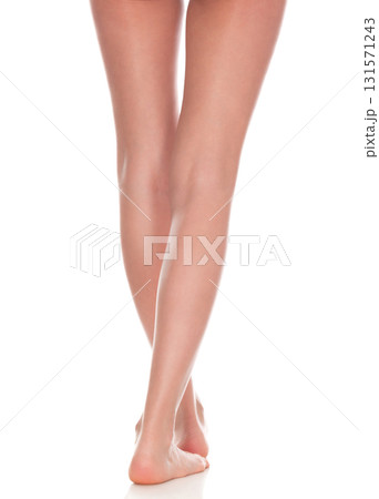 Long female legs isolated on white background. Skin care concept. Wellness and bodycare Long female legs isolated on white background. Skin care concept. Wellness and bodycare 131571243