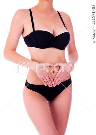 Female health care concept. Woman in black bikini on white background, isolated Female health care concept. Woman in black bikini on white background, isolated 131571488