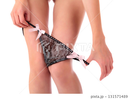 Closeup shot of woman pulling down her panties, isolated on white background 131571489
