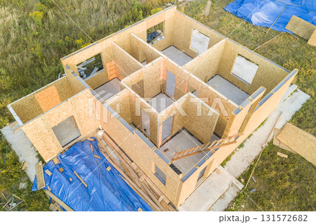 Construction of new and modern modular house. Walls made from composite wooden sip panels with styrofoam insulation inside. Building new frame of energy efficient home concept. Construction of new and modern modular house. Walls made from composite wooden sip panels with styrofoam insulation inside. Building new frame of energy efficient home concept. 131572682