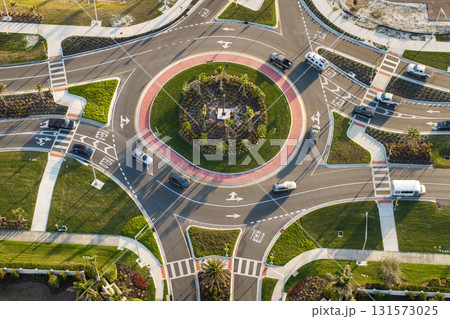 City street roundabout crossroads in Florida. Traffic infrastructure in USA. Road traffic circle intersection with driving cars 131573025