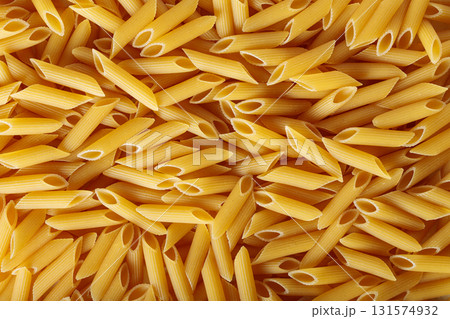 Golden Yellow Penne Pasta Tubes with Wheat Durum Top View Golden Yellow Penne Pasta Tubes with Wheat Durum Top View 131574932