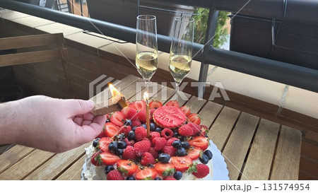 Summer celebration with cake and champagne on rustic balcony Summer celebration with cake and champagne on rustic balcony 131574954
