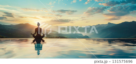 Meditation at sunrise by infinity pool with mountain view 131575696