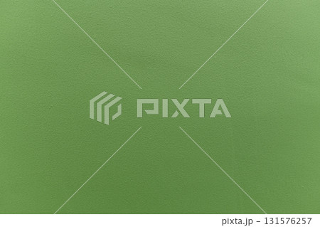Green textured wall surface with subtle paint grain and soft even lighting evoking calm and minimal mood Green textured wall surface with subtle paint grain and soft even lighting evoking calm and minimal mood 131576257