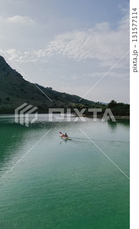 Father and daughter kayaking on picturesque Lake Kournas in Crete. Father and daughter kayaking on picturesque Lake Kournas in Crete. 131577114