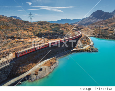Aerial view of modern red train, turquoise mountain lake 131577158