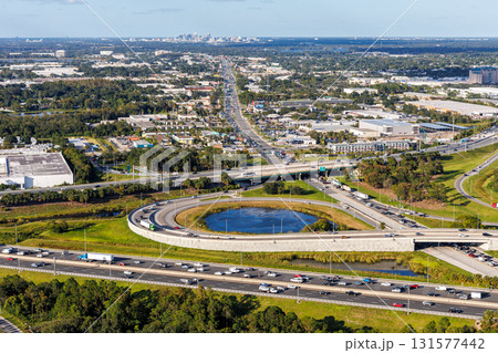 Aerial view on interstate crossing with Floridas Turnpike and Martin Andersen Beachline Expy with downtown in the background in Orlando, United States 131577442
