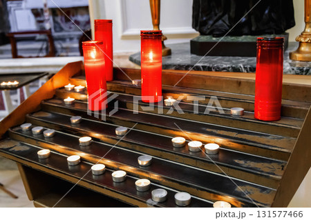 Candlelit catholic church interior with glowing light Candlelit catholic church interior with glowing light 131577466
