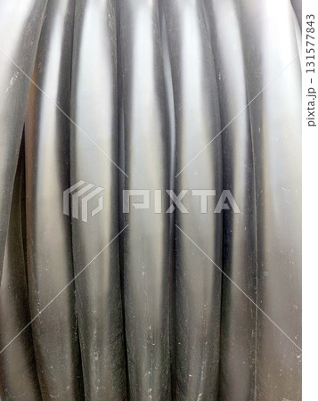 Electric High Voltage Cable Coiled on a Reel Ready for Installation on Construction Site 131577843