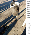 Trash Can on the Street Surrounded by Shadows Reflecting Early Morning Light 131577851