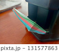 Colored Sheets for Note-Taking Arranged Neatly on a Stationery Holder at a Workspace 131577863