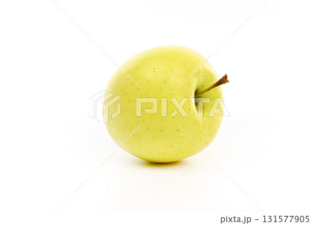 A yellow apple sits on a white background A yellow apple sits on a white background 131577905